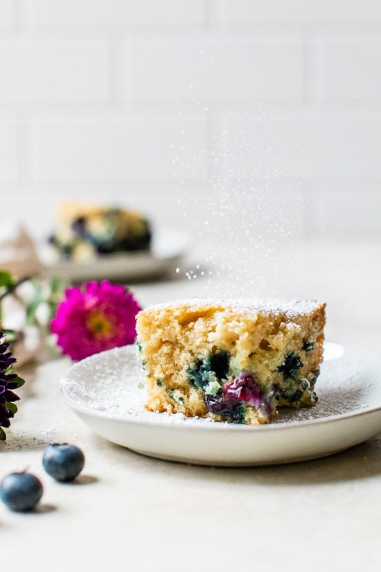 A slice of Blueberry Buttermilk Cake on a plate.
