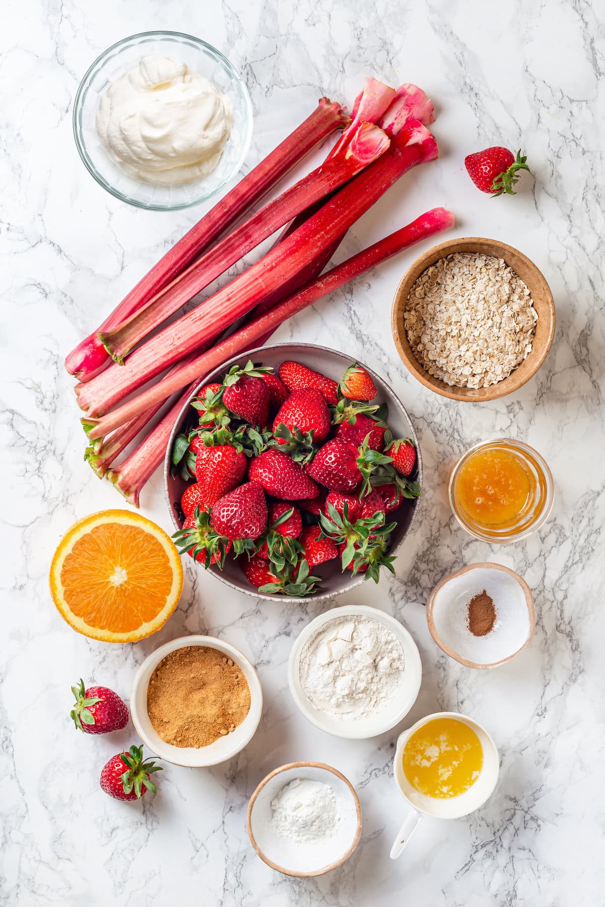 Honey adds the perfect amount of sweetness to the filling in this strawberry rhubarb crisp recipe. Easy to make and impossible to resist! Overhead view of ingredients for strawberry rhubarb crisp