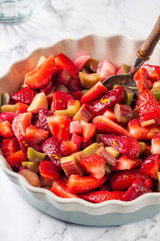 Honey adds the perfect amount of sweetness to the filling in this strawberry rhubarb crisp recipe. Easy to make and impossible to resist! Strawberry and rhubarb in baking dish