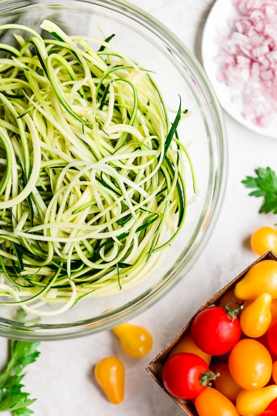Angel hair pasta tossed with summer zucchini and tomatoes fresh from the garden. The perfect meatless meal you'll be craving again and again. Serve this with plenty of Parmigiano Reggiano!