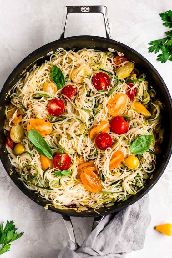 Angel hair pasta tossed with summer zucchini and tomatoes fresh from the garden. The perfect meatless meal you'll be craving again and again. Serve this with plenty of Parmigiano Reggiano!