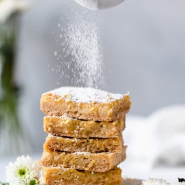Pucker Up! These sweet and tangy Honey Lemon Bars made with fresh lemon, lemon zest and honey and a whole wheat shortbread crust are a little lighter than traditional lemon bars, but are so tasty and hard to resist.