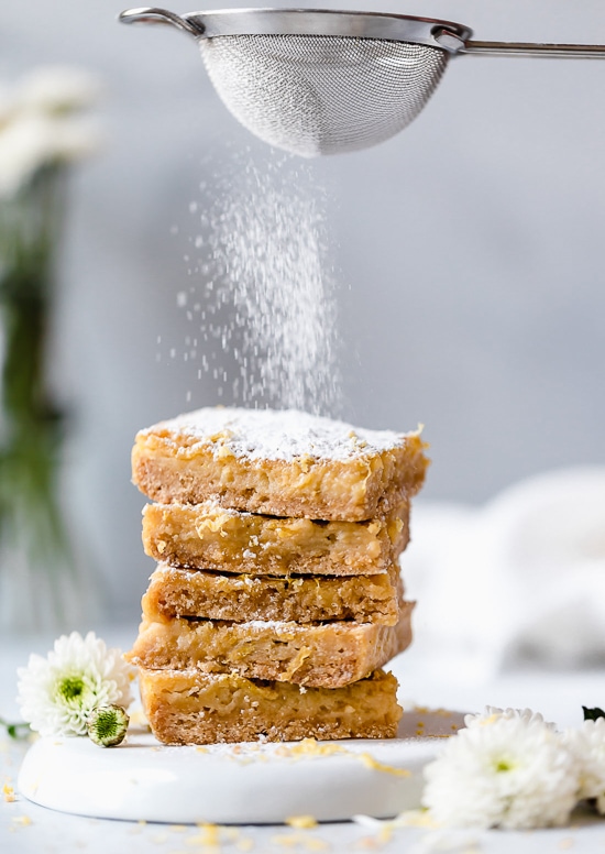 Pucker Up! These sweet and tangy Honey Lemon Bars made with fresh lemon, lemon zest and honey and a whole wheat shortbread crust are a little lighter than traditional lemon bars, but are so tasty and hard to resist. 