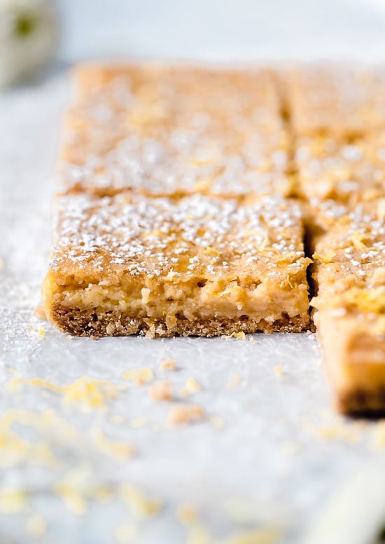 Pucker Up! These sweet and tangy Honey Lemon Bars made with fresh lemon, lemon zest and honey and a whole wheat shortbread crust are a little lighter than traditional lemon bars, but are so tasty and hard to resist.