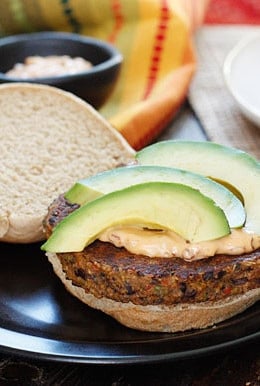 One bite of this spicy black bean burger with spicy chipotle mayo and creamy avocado and you won't miss the meat! Yes, these were good enough to please even the adult carnivore's in my home (a bit too spicy for my kids).