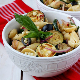 This warm pasta salad is big on summer vegetables, corn and zucchini, with a small kick of red pepper. A great sub to potato salad and a perfect meatless entree or side dish for your next picnic or family potluck.