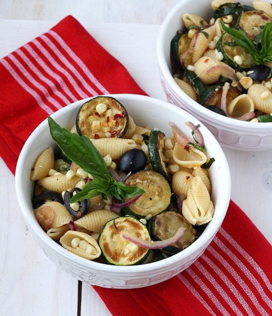 This warm pasta salad is big on summer vegetables, corn and zucchini, with a small kick of red pepper. A great sub to potato salad and a perfect meatless entree or side dish for your next picnic or family potluck.