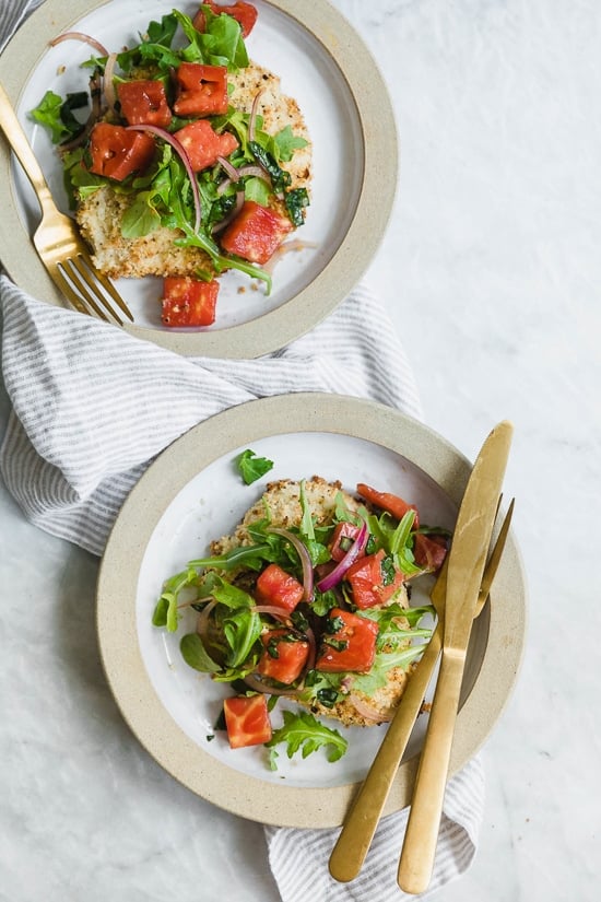 Baked Chicken Milanese is made with breaded chicken cutlets, baked in the oven topped with arugula, tomatoes and balsamic. This is my favorite restaurant dish, made healthier!