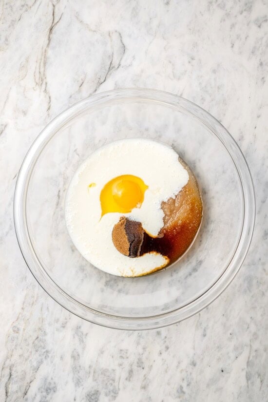 Buttermilk gives these spiced apple scones a moist, tender crumb, while applesauce replaces much of the butter to lighten them up! Overhead view of wet ingredients in bowl before mixing