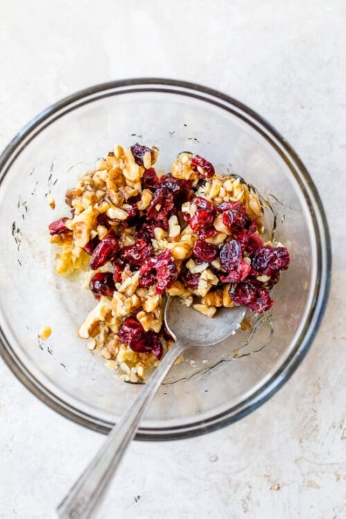nuts craisins and honey in a bowl
