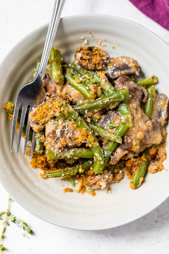 This Green Bean Casserole From Scratch features fresh green beans, cremini mushrooms, shallots, and grated parmesan. Green Bean Casserole on a plate.