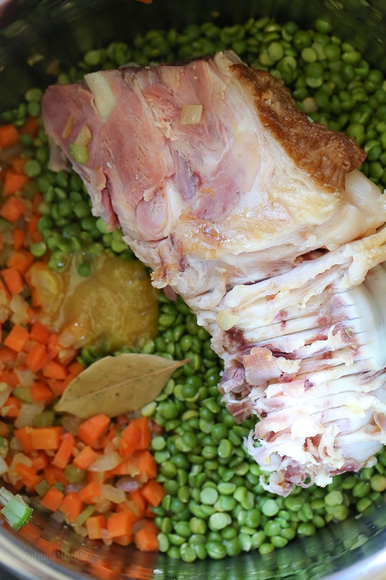 Ready in 30 minutes, this Instant Pot Split Pea Soup with Ham is the perfect way to use up that leftover ham and ham bone from the holidays! Ham bone, split peas, and carrots in the Instant Pot