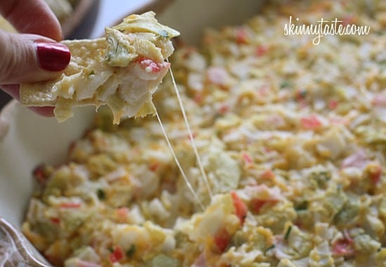 Hot and cheesy imitation crab and artichoke dip is to die for! Serve this glorious dip with baked chips and you will have the perfect appetizer for any party.