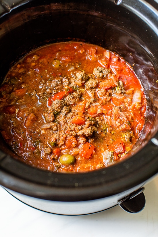 Crock Pot Picadillo is a flavorful Cuban dish made with ground beef and a sauce made from simmering tomatoes, green olives, bell peppers, cumin, and spices.
