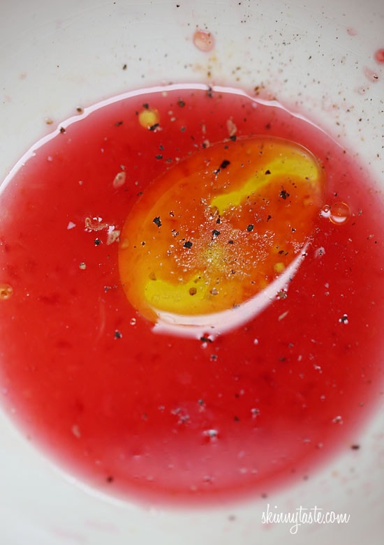 A bowl of blood orange juice mixed with olive oil and ground black pepper