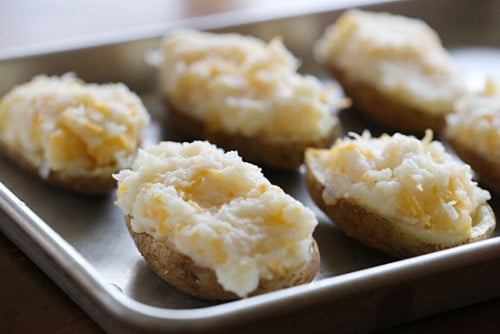 Baked potatoes on a sheet pan with cheese