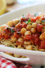 Sauteed bay scallops with tomatoes and a touch of white wine and lemon juice served over angel hair pasta.