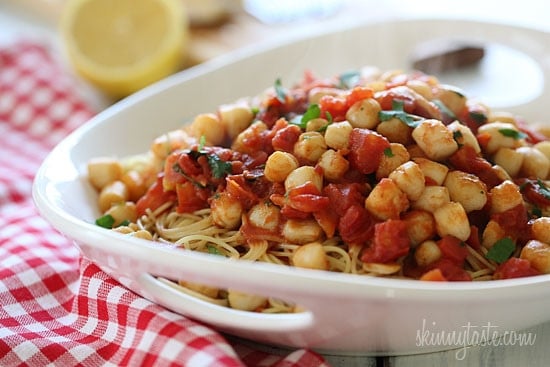 Sauteed bay scallops with tomatoes and a touch of white wine and lemon juice served over angel hair pasta.