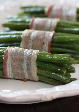 Pretty little bundles of bacon wrapped French "green beans" known as Haricot verts which are longer and thinner than the typical American green beans. Of course, American green beans will work just fine here too.