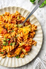 Overhead view of cheeseburger casserole on plate with fork