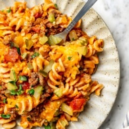 Overhead view of cheeseburger casserole on plate with fork