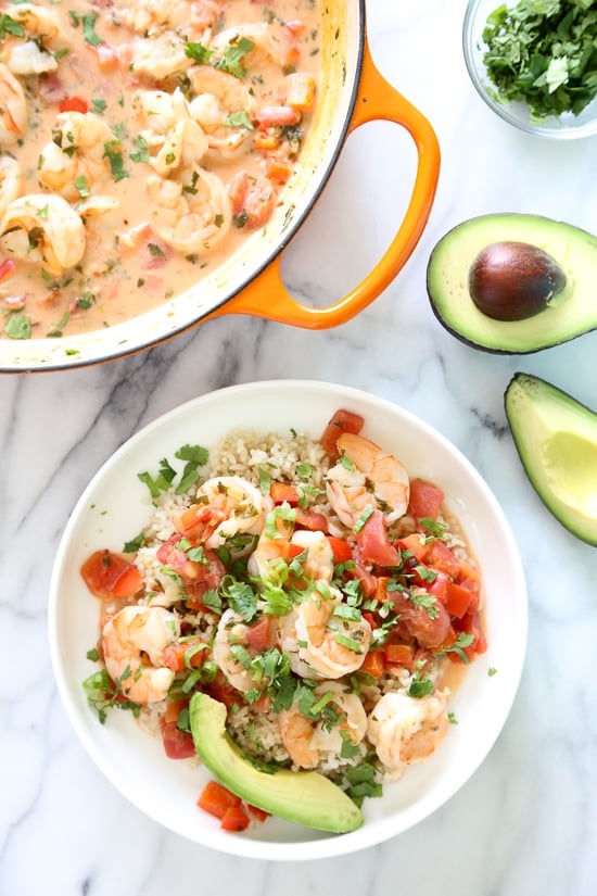 Garlic Shrimp in Coconut Milk, Tomatoes and Cilantro is a quick stew cooked in a light, tomato coconut broth with a hint of lime and cilantro. Simple enough to make for a weekday dinner yet sophisticated enough to serve to company. Serve with a little brown basmati rice to soak up the delicious broth.