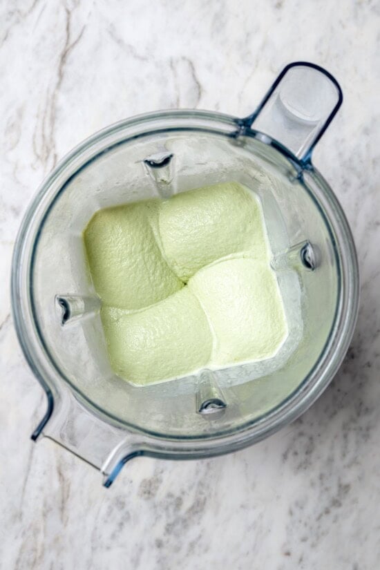 This easy homemade shamrock shake recipe is thick, creamy, and minty just like the original—with a fraction of the calories! Top-down view of shamrock shake in blender