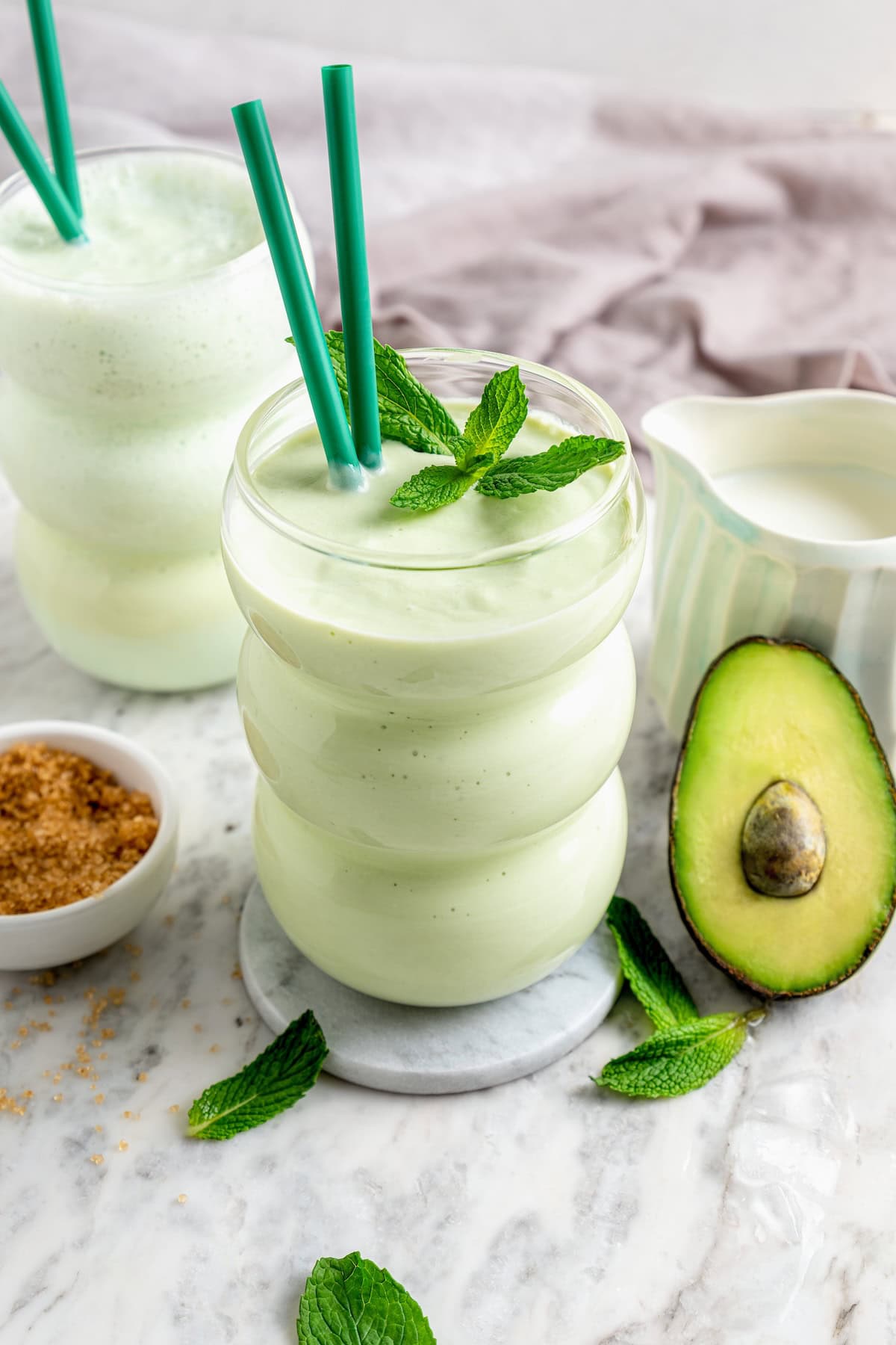 This easy homemade shamrock shake recipe is thick, creamy, and minty just like the original—with a fraction of the calories! Two glasses filled with homemade shamrock shake