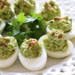 Guacamole Deviled Eggs make a healthy appetizer made with hard boiled eggs filled with mashed avocado, cilantro and lime juice.