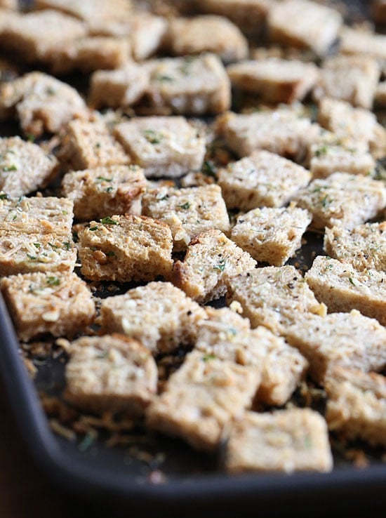 Healthier homemade croutons made with whole grain bread, Italian seasoning and shredded parmesan cheese.