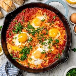 Overhead view of eggs in purgatory in skillet