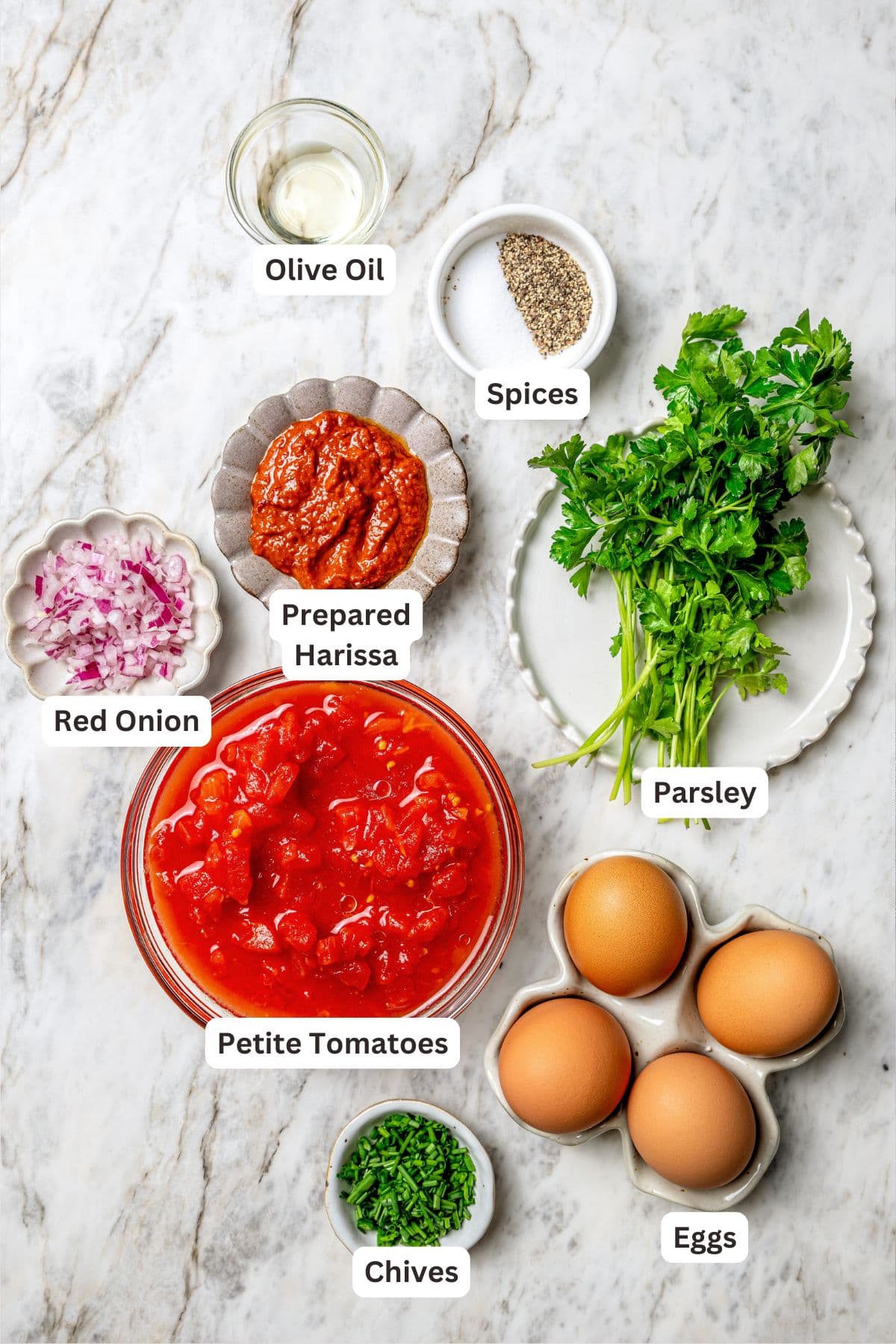 Overhead view of ingredients for eggs in purgatory