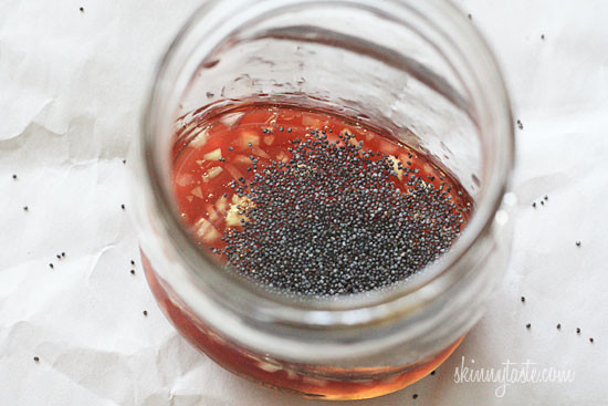 Strawberry salad made with mixed greens, kale and spinach, sliced almonds, crumbled gorgonzola cheese and topped with poppy seed dressing – perfect for summer!