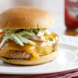 Turkey burgers with a cayenne pepper kick! Here's a fun way to turn boring turkey burgers into something with a little more exciting. If you're a buffalo wing fan, you'll love the flavors in this turkey burger topped with a broccoli slaw tossed with my very own homemade blue cheese dressing.