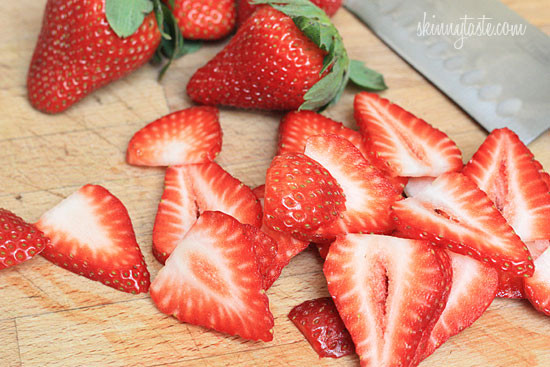 Strawberry salad made with mixed greens, kale and spinach, sliced almonds, crumbled gorgonzola cheese and topped with poppy seed dressing – perfect for summer!