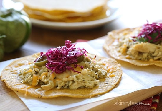 Chicken tenders are slow cooked in the crock pot with salsa verde, then served on a crispy corn tostada and topped with melted cheese, jalapeño and a simple cabbage slaw made with red cabbage, lime juice, cilantro and salt. I could eat these everyday!!