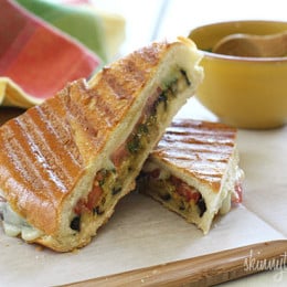 A perfect summer lunch panini made with eggplant, tomatoes, mozzarella and skinny pesto on crispy French bread. Make this for one, or for the whole family.