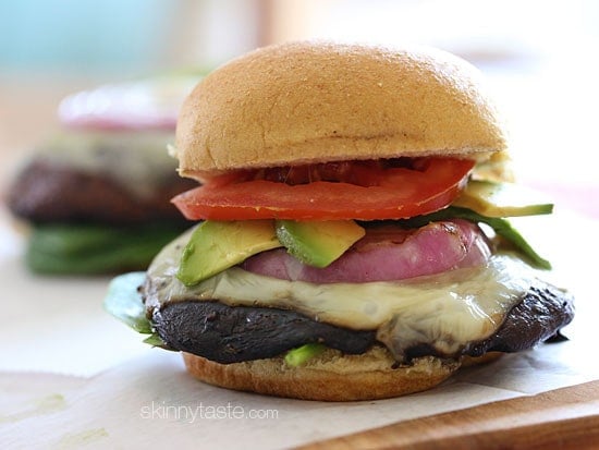 I set out to make a great tasting grilled portobello mushroom burger that even a meat lover would love. The mushrooms are marinated then grilled and topped with melted Swiss Cheese, grilled red onion,  tomatoes, spinach, and avocado – yum!!