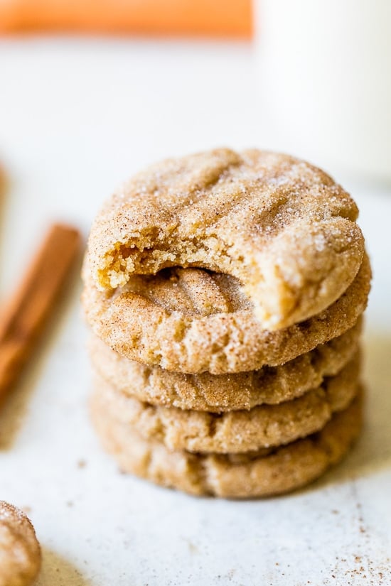 A simple sugar cookie dough is rolled in sugar and pumpkin pie spice to make these soft and chewy Pumpkin Snickerdoodles. Pumpkin Snickerdoodles stacked