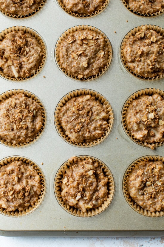 These apple cinnamon muffins are packed with sweet apples, crunchy walnuts, and a hint of spice. Add granola on top for a bit of crunch! Muffin batter ready to bake.