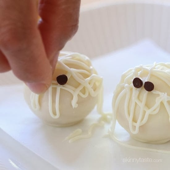 Easy Skinny Halloween mummy cake balls made light by using a box cake mix, egg whites and fat free Greek yogurt – no butter required!
