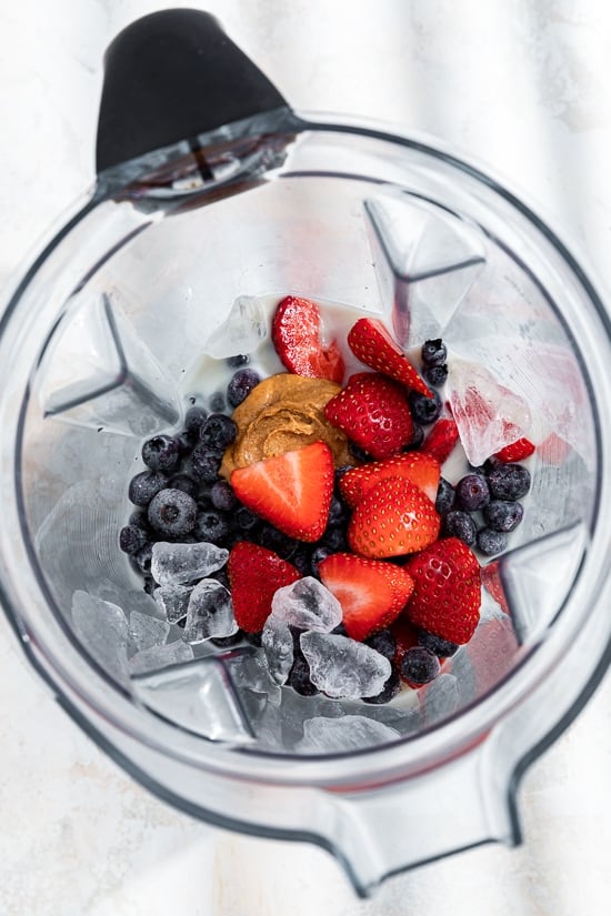 berries and peanut butter in a blender