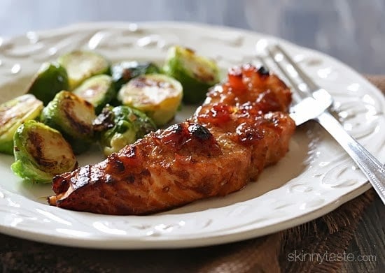 A plate with broiled wild salmon with cherry apple chutney and roasted brussels sprouts