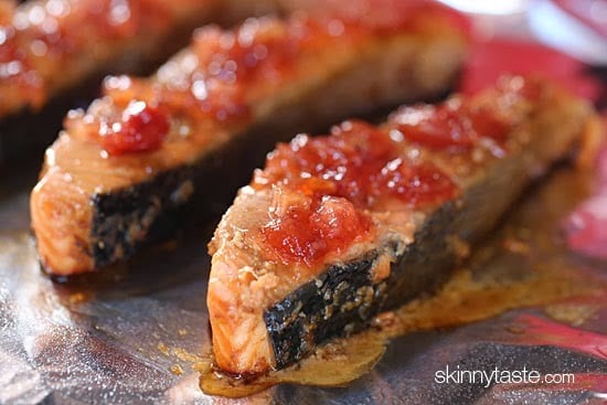 Broiled salmon fillets on a sheet of foil topped with apple cherry chutney