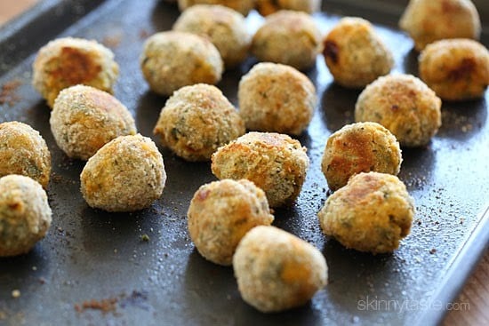 A sheet pan with baked crispy mini arancini rice balls