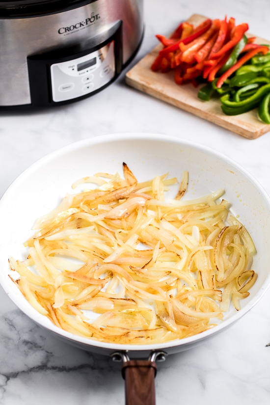 Slow Cooker French Dip Sandwich with Caramelized Onions filled with beef, melted cheese and au jus (beef broth) for dipping–the perfect weekend crock pot recipe!