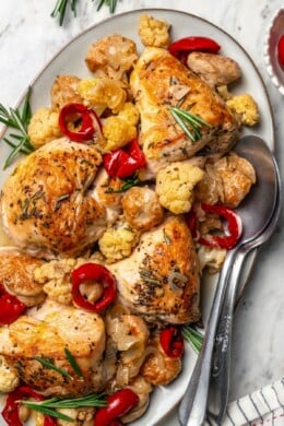 Platter of chicken scarpariello with sausage, peppers, and cauliflower.