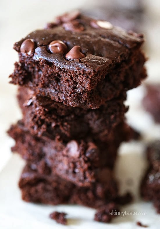 You'll never guess they're made with beans! These fudgy Black Bean Brownies are moist, chocolatey and delicious. So easy to make too! Stack of fudgy black bean brownies with chocolate chips