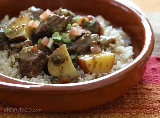 Crock pot carne guisada is a slow cooked Latin beef stew with baby red potatoes and Latin seasonings. Serve this topped with fresh aji picante – it's a must and really brightens the flavors and rounds out the dish!