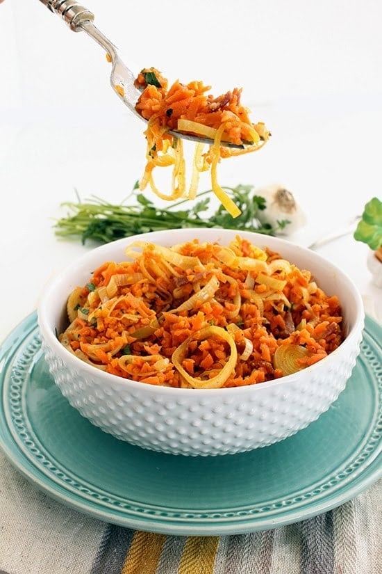 While you dig your fork into this fluffy bowl of spiralized carrot "rice" leek risotto with bacon, you won’t believe it’s not real rice.